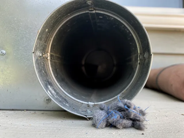 Upland Dryer Vent Cleaning technician using specialized equipment to clear severe dryer vent blockage in Upland